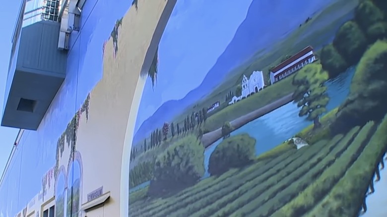 Mural of lakeside villa painted on wall