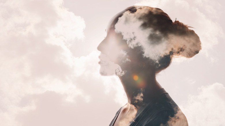 Woman's mind superimposed over sky