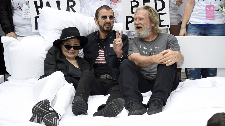 Ono, Starr (center) and actor Jeff Bridges laying in bed