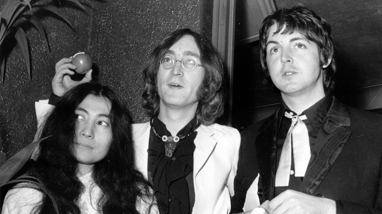 Yoko Ono, John Lennon and Paul McCartney looking up