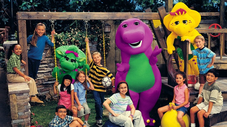 Barney & Friends cast on a swingset