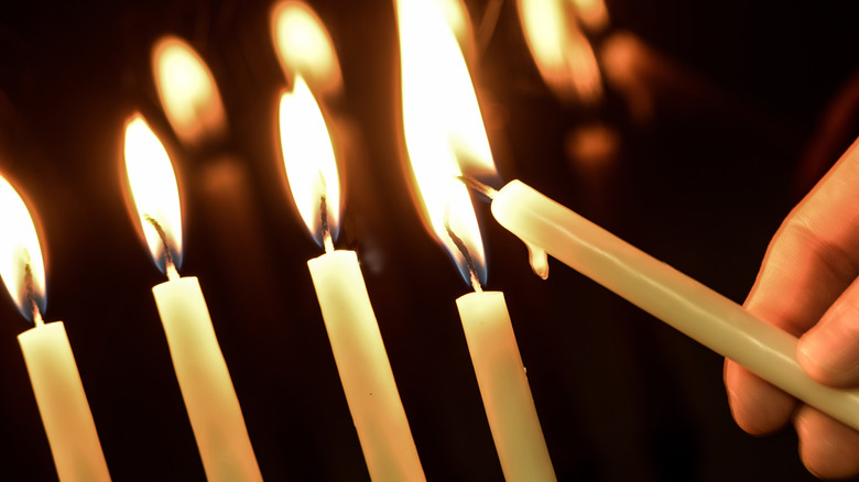 Shamash candle lighting menorah