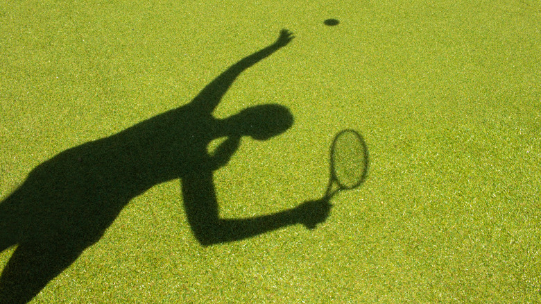 female tennis player in shadow