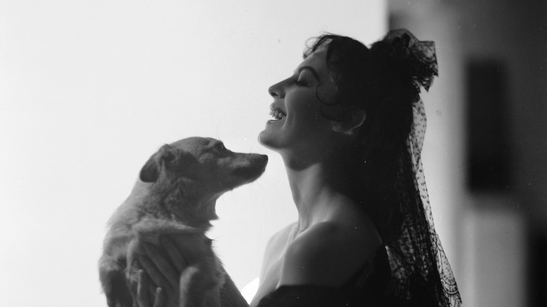 Ava Gardner holding a dog