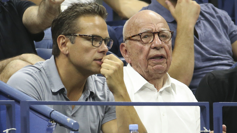 Lachlan and Rupert Murdoch watching tennis