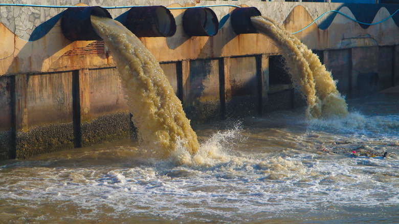 Industrial waste being dumped into a waterway