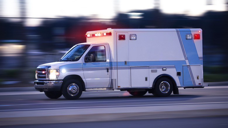 blue ambulance racing down the street