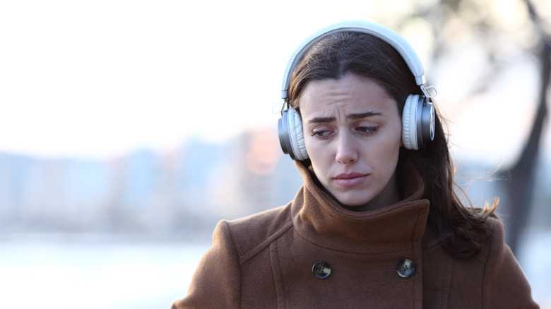 A woman listening to sad music