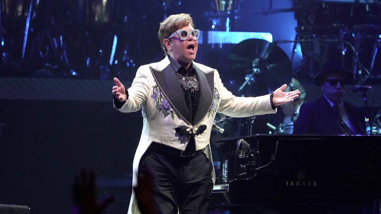 Elton John singing at concert