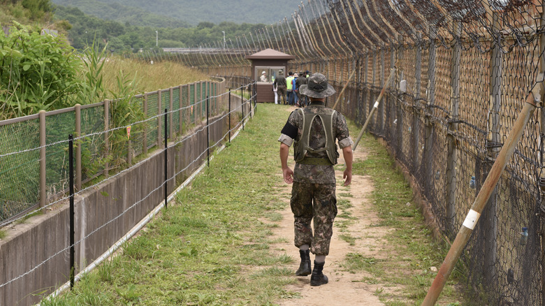 South Korean soldier walking along DMZ fence