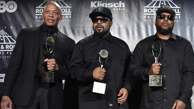 Dr. Dre, Ice Cube, and MC Ren holding awards