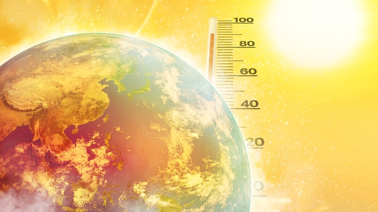 Earth and a thermometer indicating heat