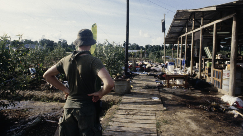 U.S. soldier looking over Jonestown remains, 1978