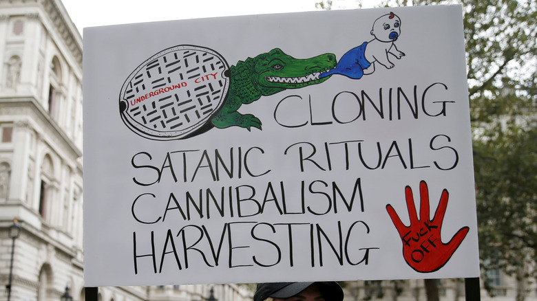 Protest sign denouncing satanic rituals 
