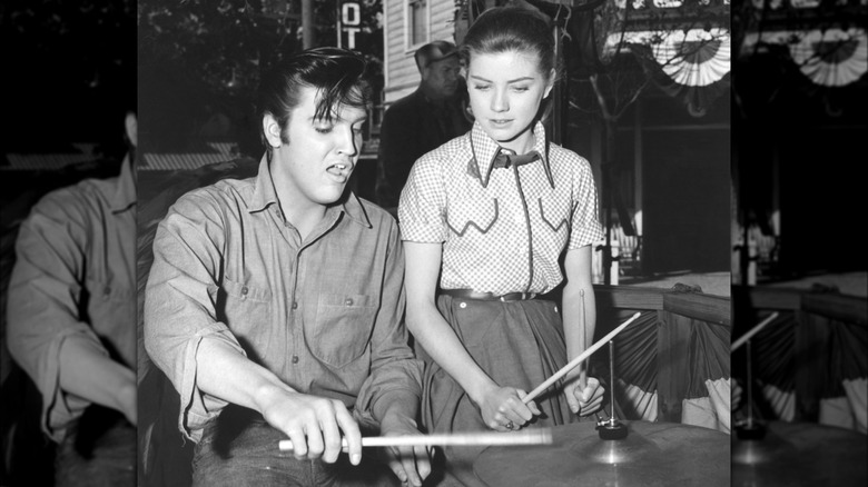 Elvis sitting at the drums with Dolores Hart
