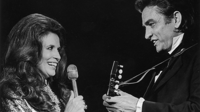 Johnny Cash and June Carter Cash performing on stage